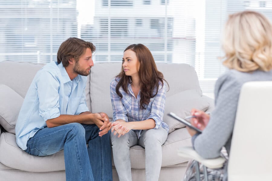 Struggling couple receiving couple's counseling from a therapist