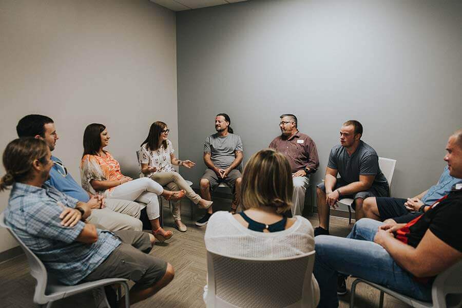 Patients sitting in a circle during a drug rehab therapy session