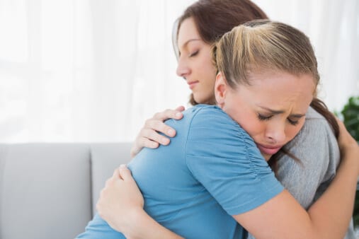 Woman consoling her friend with a hug