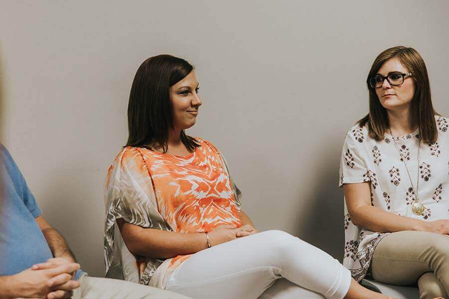 Female patients smiling in an addiction treatment group therapy session at Beaches Recovery