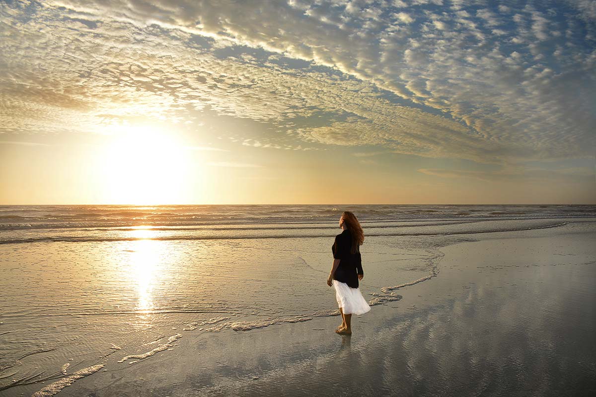 woman watching the sunset at the beach after a Jacksonville addiction treatment program