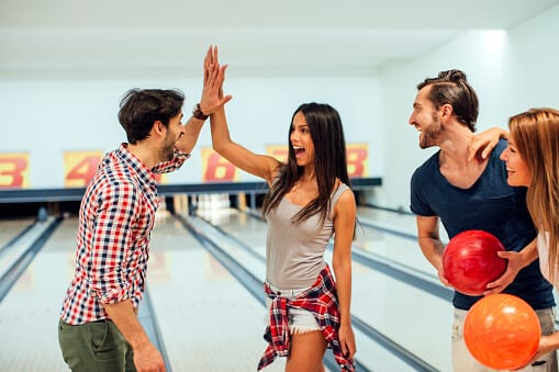 Cheerful Friends Bowling Together