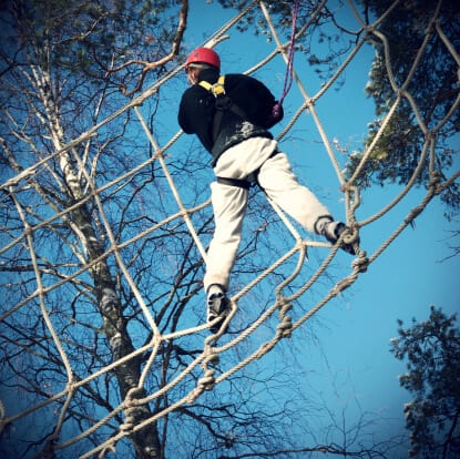Person climbing a rope course