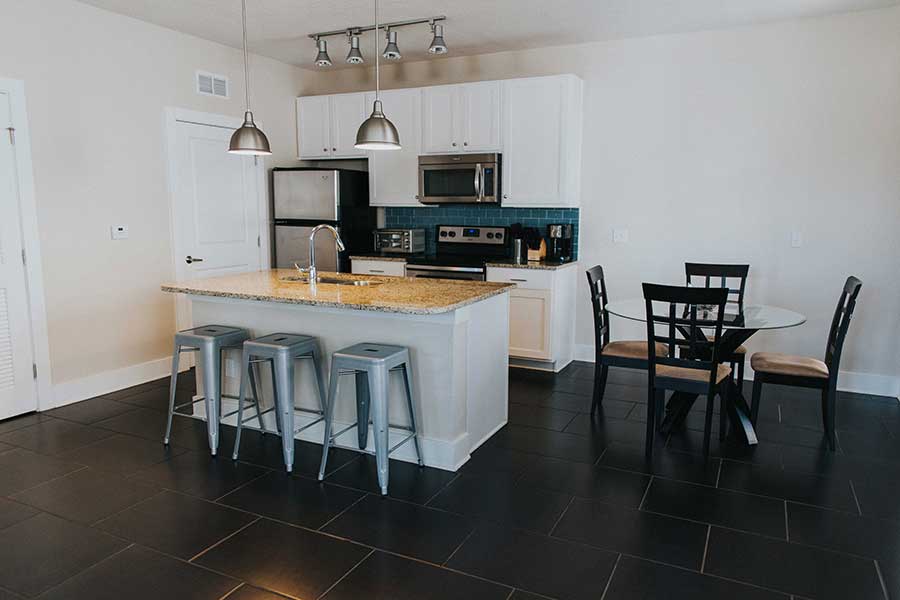 Kitchen with island and dinning table in residential living quarters for addiction treatment