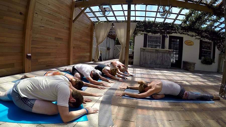 Woman guiding a yoga exercise session at Beaches Recovery