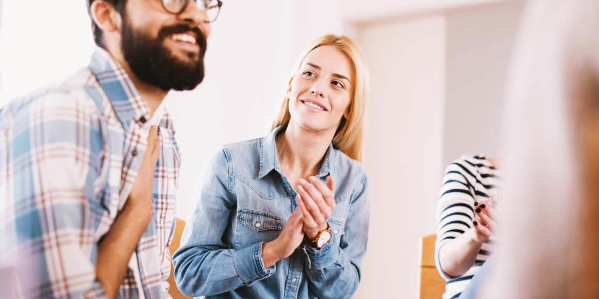 man smiling in group at drug abuse treatment programs