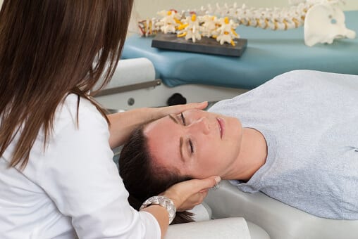 Practitioner using Chiropractic Adjustment Therapy Rehab Patient
