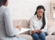 teen sitting on couch