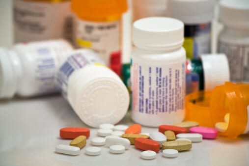 Many prescription drug bottles and pills