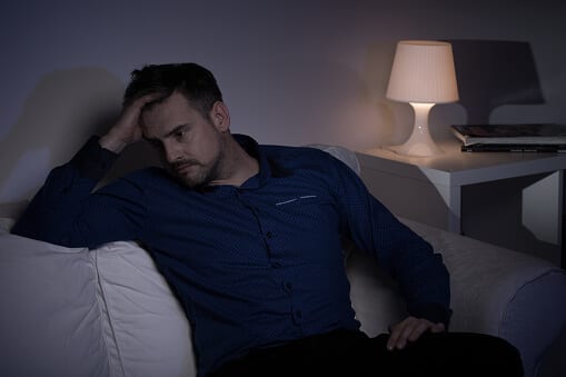 Man in dark room may develop a melatonin addiction just to get some sleep