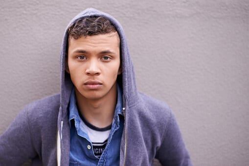 Vacant looking man against a wall knows with drug misuse.