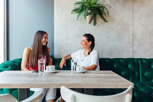 Mother and daughter discussing drug addiction treatment that is going well.