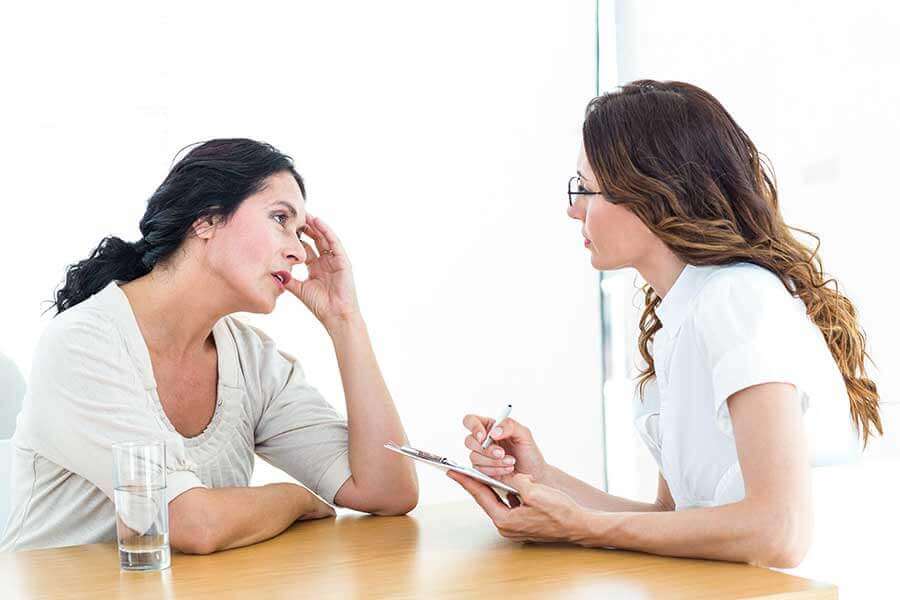 Concerned woman confiding in therapist