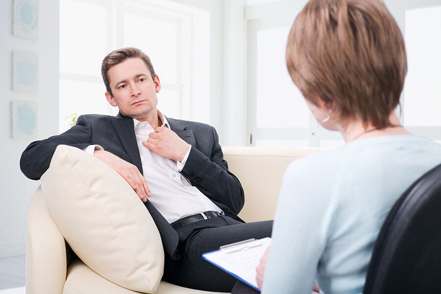 A drug and alcohol counselor helping a client during rehab.