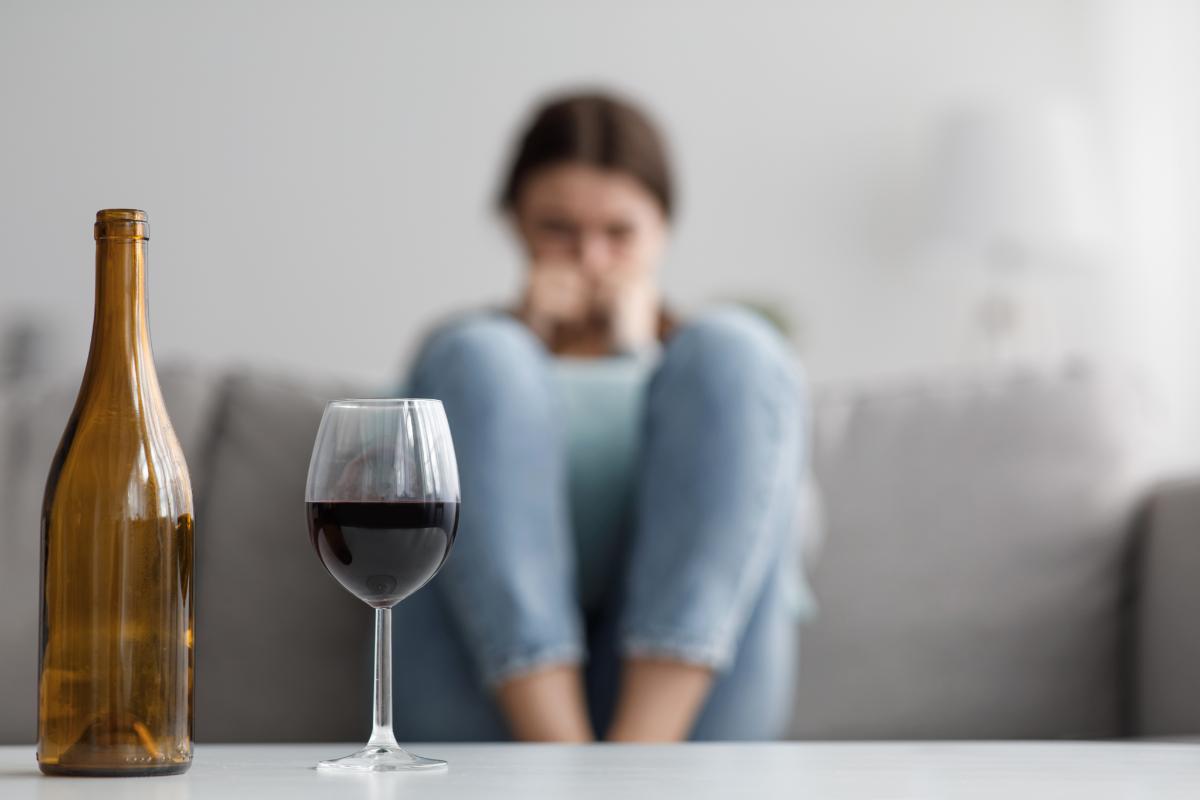 woman sitting looking at wine