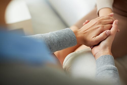 Holding hands looking for better addiction care.