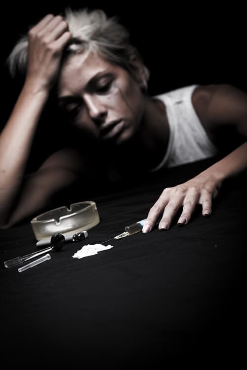 Strung out woman with drug paraphernalia distressed about possible drug overdose symptoms.