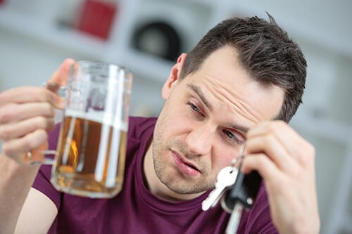 Drunk man holding beer may be suffering with chronic alcoholism.