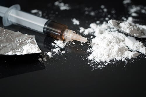 A syringe and white powder will soon show you the effects of heroin use.