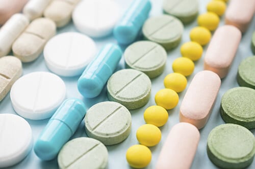 Pretty pills all lined up belie the danger of prescription opioids.