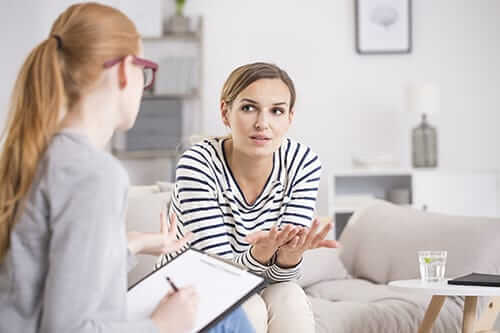 Counselor talking to woman explaining fentanyl overdose symptoms