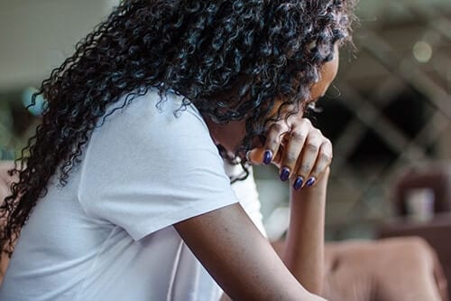 Person hiding face learning what is substance abuse