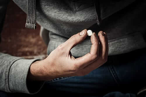 Dirty hand holding pill may know when do I need drug dependency help