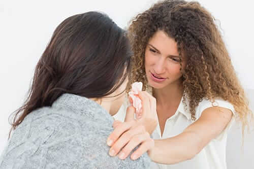 Two woman one explaining how to get off Suboxone to another woman crying