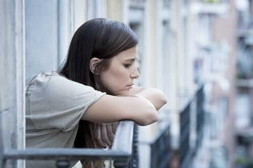 After a vicodin high, this young woman at an open window is depressed