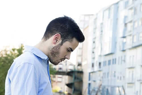 Man looking down needs mental health treatment and addiction recovery