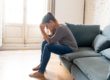 woman struggling and sitting on couch with ketamine high