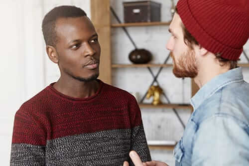 Man looks skeptically at another regarding abstinence based addiction treatment programs