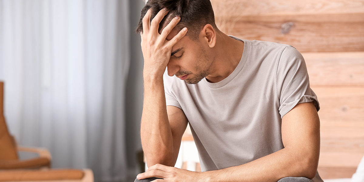 man with head in hands needing drug testing