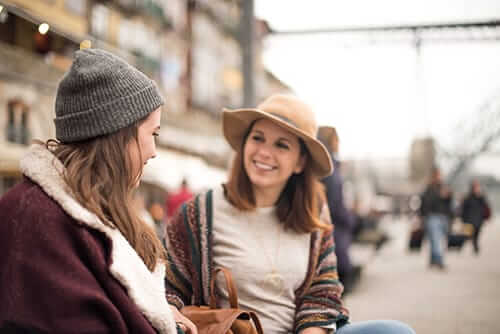 Smiling women on bench finding out about krokodil drug addiction treatment program in FL