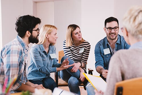 Young people at a big book study group of Alcoholics Anonymous