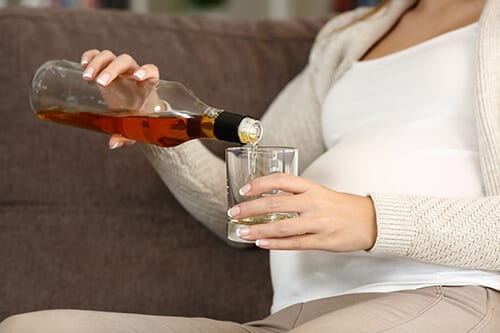Woman drinking alcohol in early pregnancy which is not a good idea