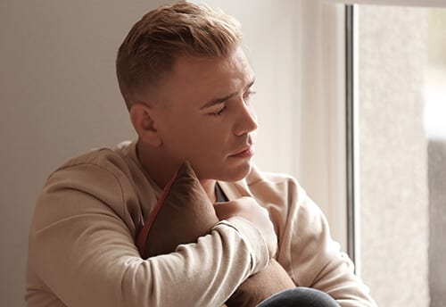 Worried and sad man wants to know what does heroin withdrawal feel like