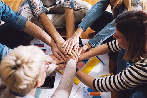 Group hand hold during addiction education and treatment