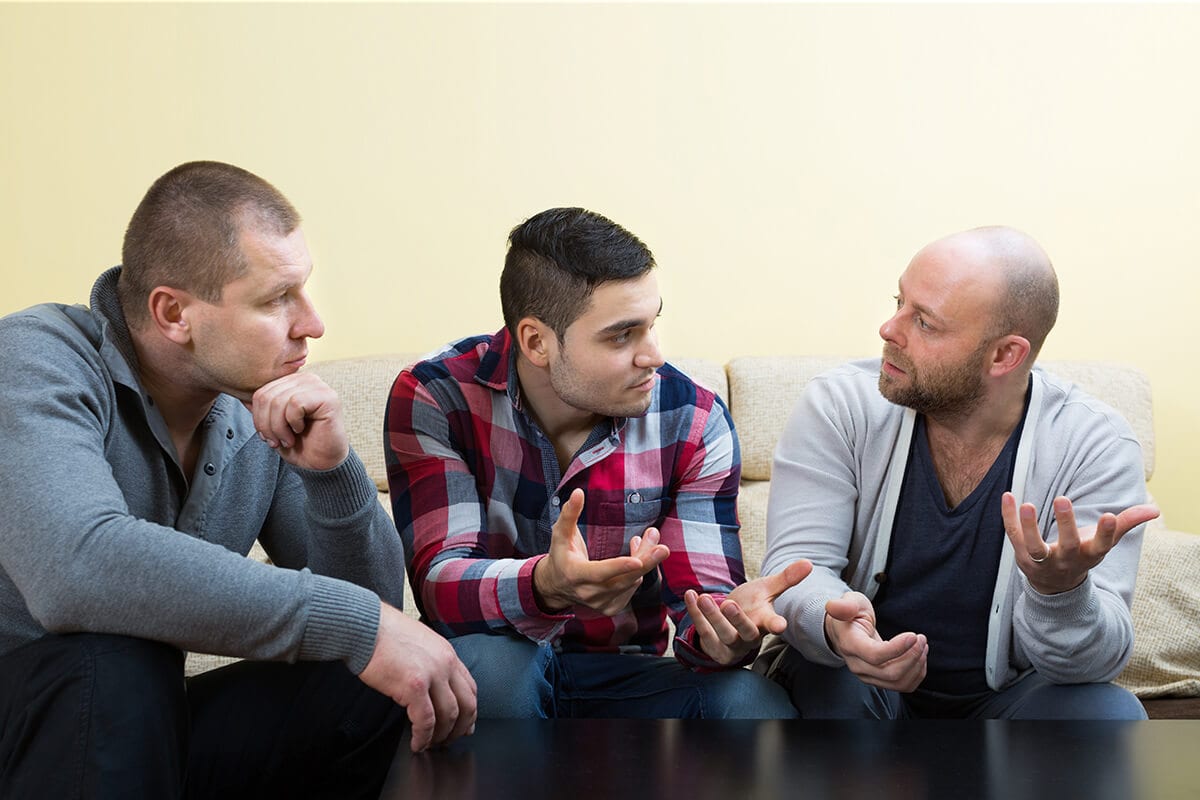 three men talk about drug rehab centers for men
