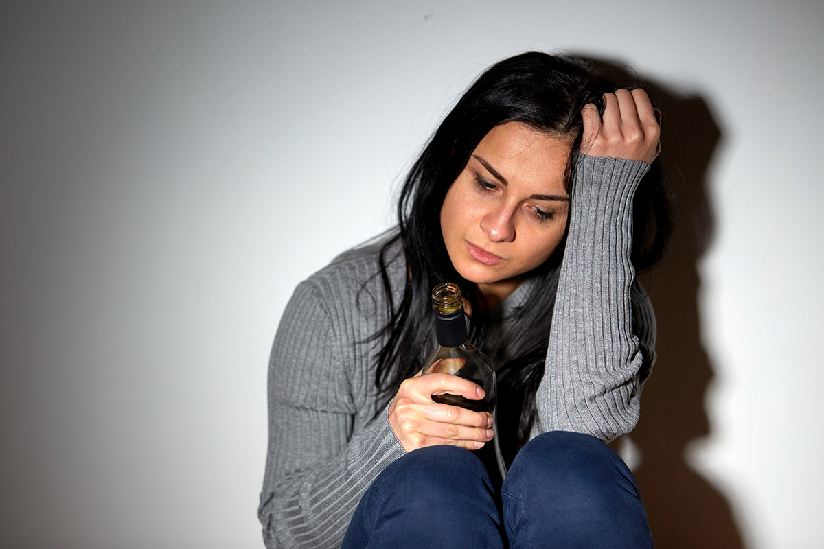 depressed woman self medicating depression with alcohol