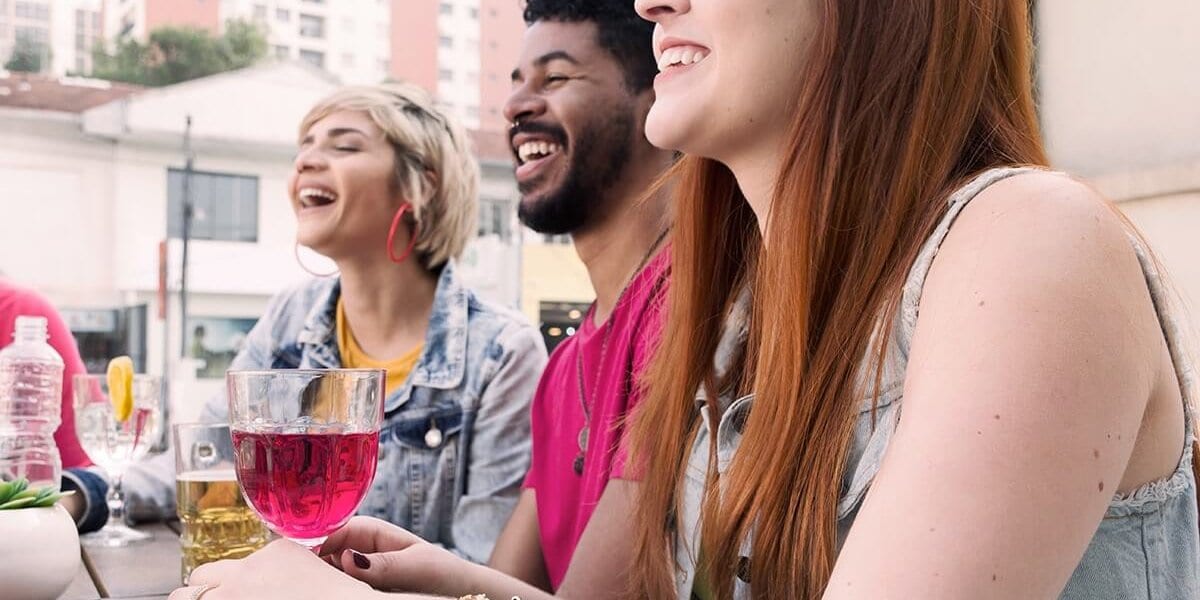 three people drinking in college