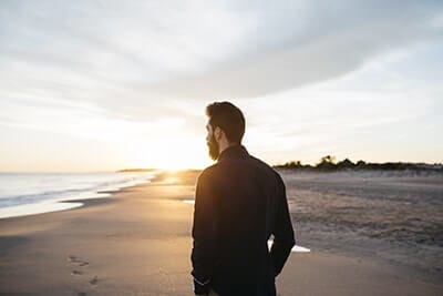 Man walks on beach at his Palm Valley FL drug rehab center