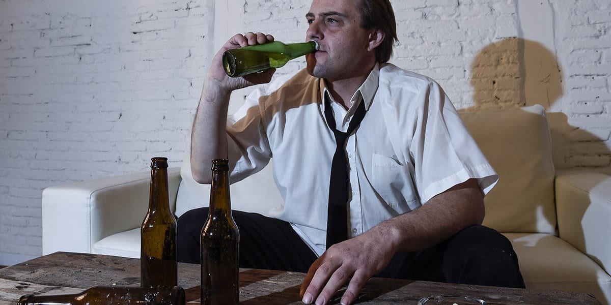 Drunk man wonders what are the signs of a drinking problem