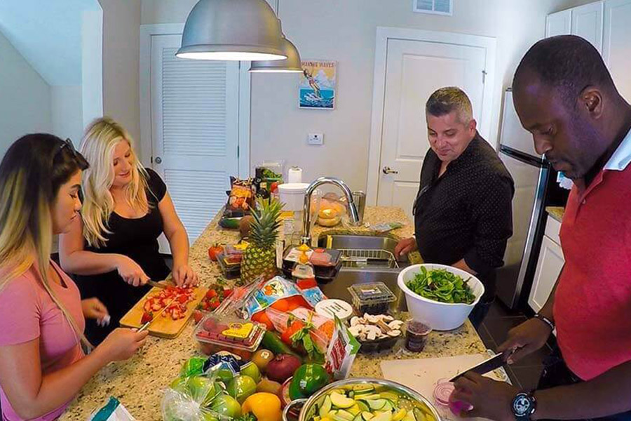 Patients in a drug rehab home preparing dinner together