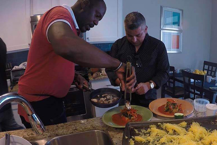 Patients serving dinner in a drug rehab house