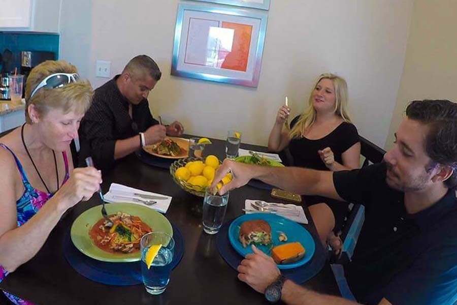 Patients in a drug rehab home eating dinner together