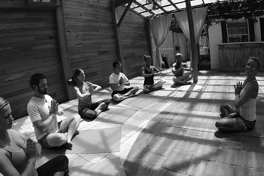 Patients sitting in a semi-circle during a yoga sesssion