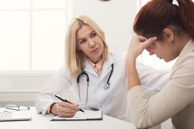 Woman talks to her doctor about chronic relapse