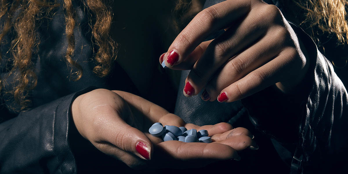 woman taking pills experiences a substance induced mood disorder