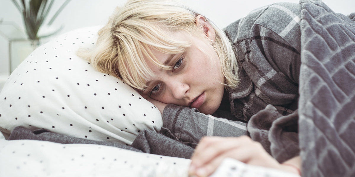 a woman in bed wondering can you mix depressants and opioids